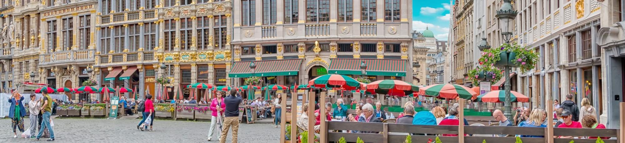 Street scene in the Grand Place market square with the Le Roy d'Espagne restaurant in the background, in the city of Brussels, which is the capitol of Belgium